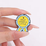 Cried A Little Brooch Enamel Pin holding in a hand
