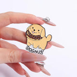 Dognut Brooch Enamel Pin holding in a hand