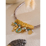 18k Gold Plated Sea Life Necklace placed on a table