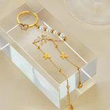 18K Gold Plated Pearl Butterfly Hand Chain place on a table