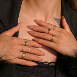 Different gold plated rings wore on two hands 